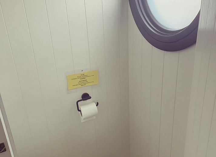 Attractive bedroom in The White Houseboat, a unique vacation accommodation for 2 persons in Lathum, Rivierengebied, Gelderland.