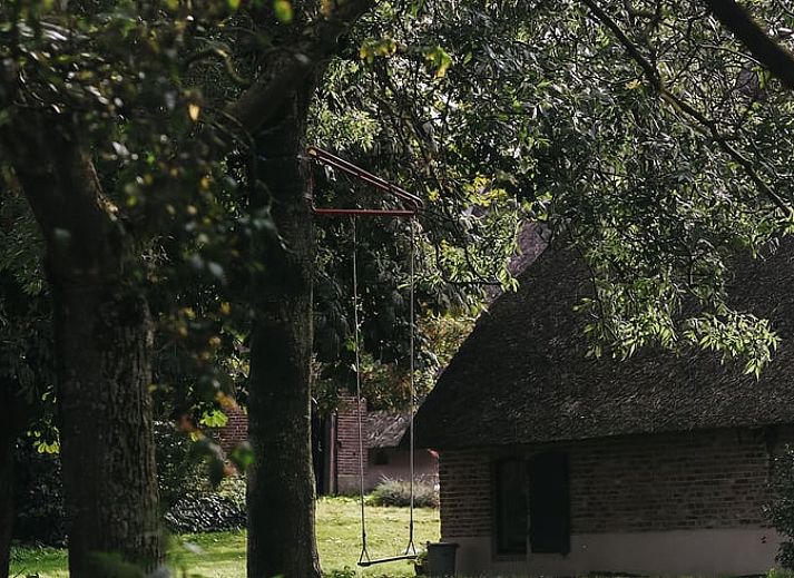 Attractive bathroom in Holiday Home in Altforst, Gelderland, with freestanding bathtub and rustic wooden elements for a relaxing stay.