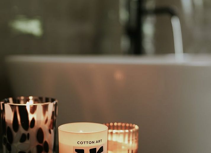 Relaxing bathroom experience at Holiday Home in Altforst, Gelderland with candles for a serene atmosphere.
