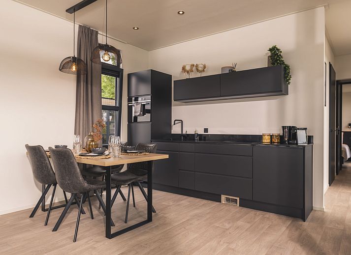 Terrasse mit bequemem Loungesofa im Ferienhaus MarinaPark Bad Nederrijn in Maurik, Gelderland mit Blick auf den Fluss.