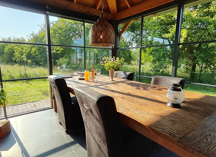 Geraeumiger Innenbereich im Ferienhaus in Herveld, Gelderland. Gemuetliche Sitzecke mit Blick in die Natur.