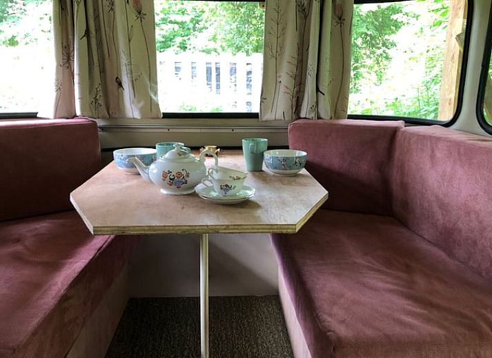 Enjoy an idyllic stay at Holiday Home in Dreumel, Gelderland, with a charming caravan and cozy outdoor seating in nature.