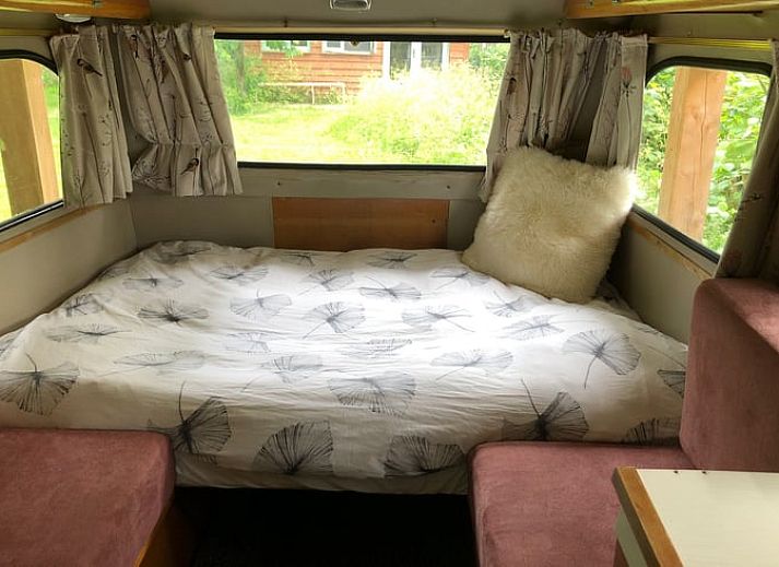 Enjoy an idyllic stay at Holiday Home in Dreumel, Gelderland, with a charming caravan and cozy outdoor seating in nature.