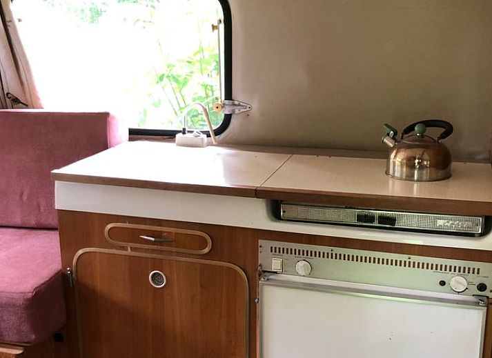 Enjoy an idyllic stay at Holiday Home in Dreumel, Gelderland, with a charming caravan and cozy outdoor seating in nature.