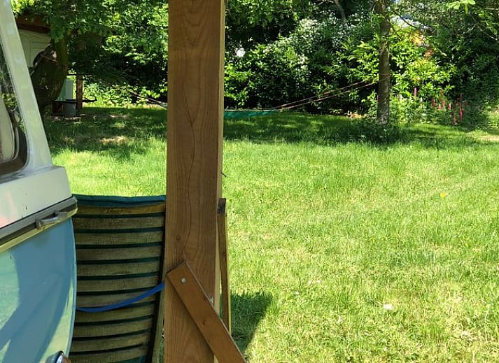 Cozy indoor area of Holiday Home in Dreumel, Gelderland with comfortable seating area and view of green surroundings.