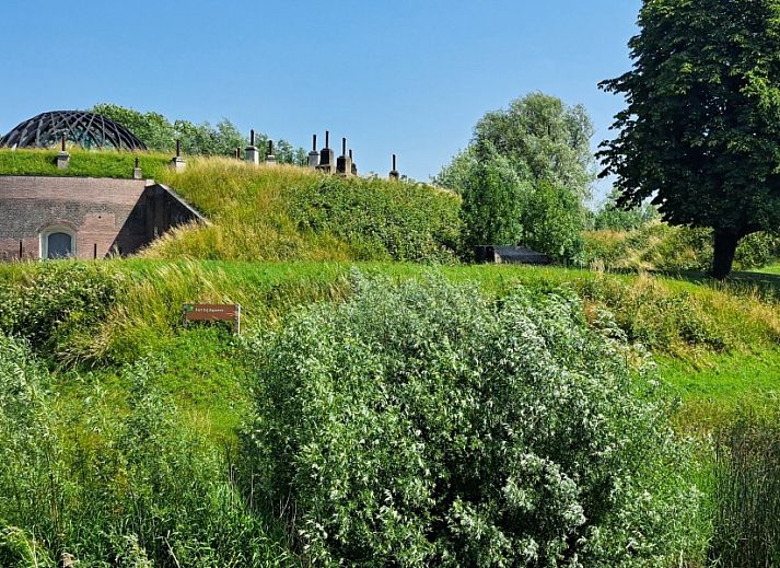 Cozy indoor area of Betuwsend in Acquoy, Gelderland, with sitting area and access to terrace for a relaxing stay.