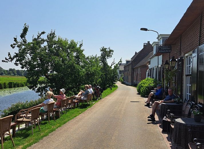 Cozy indoor area of Betuwsend in Acquoy, Gelderland, with sitting area and access to terrace for a relaxing stay.