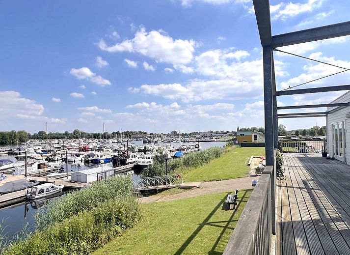 Stilvolles Wohnzimmer im Ferienhaus Havenzicht, Maasbommel, mit bequemem Sofa und moderner Einrichtung in Gelderland.
