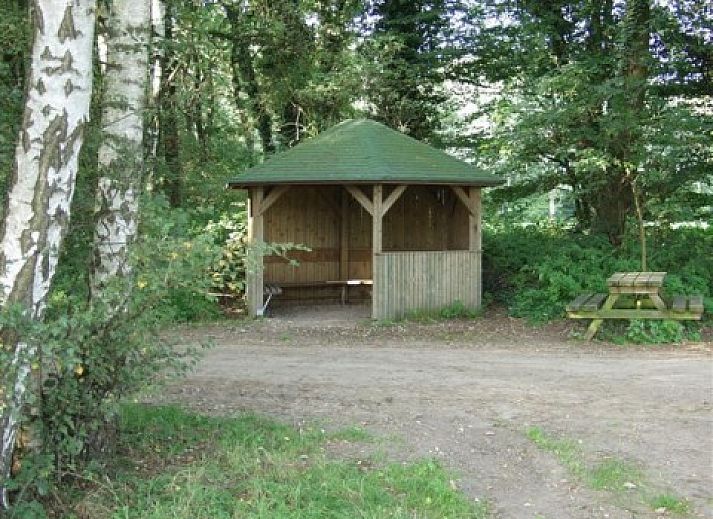 Stijlvolle woonkamer met bloemen in Vakantiewoning Hogeweg, Winterswijk, gelegen in de prachtige Achterhoek.