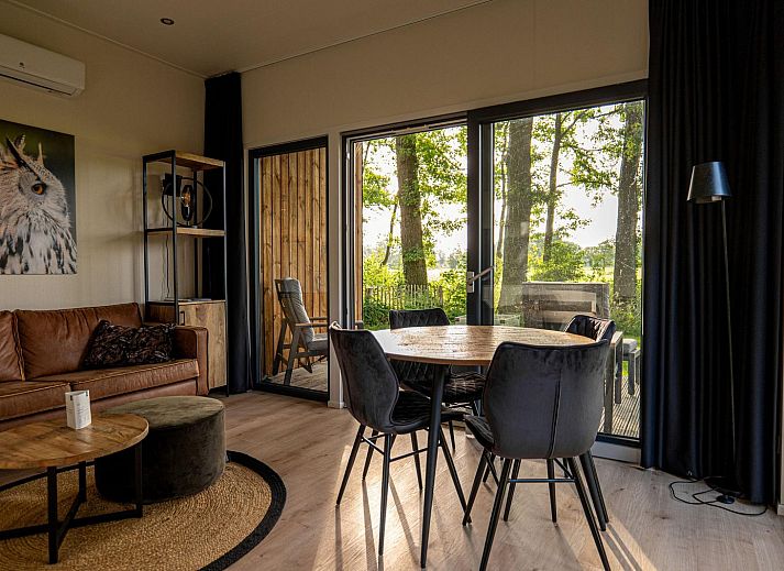 Cozy living room of Holiday Villa Amalia 2 in Kotten, overlooking nature.