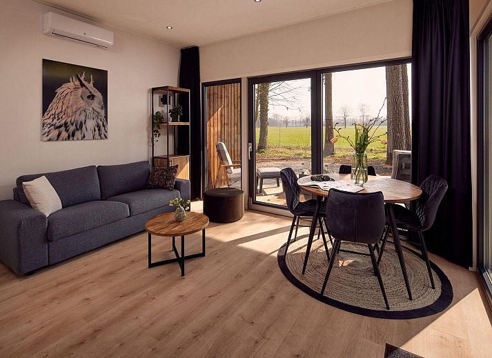 Dining area in Holiday Villa Amalia 2, Kotten, overlooking green surroundings.