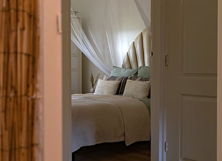 Modern kitchen in Huisje in Halle, vacation home in the Achterhoek region, Gelderland, with green walls and natural light.