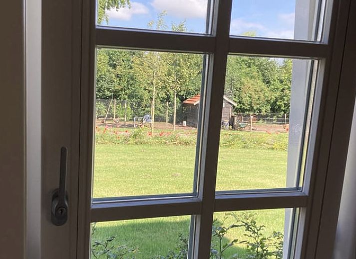 Cozy bedroom in Huisje in Westendorp, bed and breakfast in the Achterhoek, with wooden ceiling and soothing green walls.