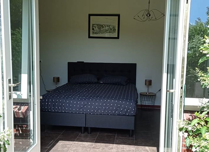 Enjoy the green surroundings on the terrace of Huisje in Aalten, a charming vacation home in the Achterhoek region of Gelderland.