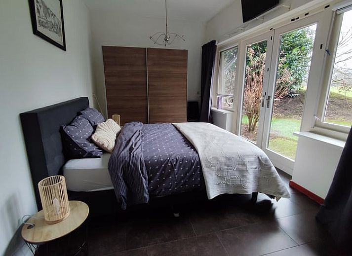 Enjoy the green surroundings on the terrace of Huisje in Aalten, a charming vacation home in the Achterhoek region of Gelderland.