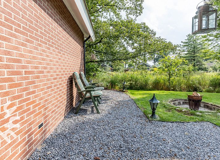 Cozy outdoor area of vacation home DG1024 in Aalten, Achterhoek, surrounded by greenery.