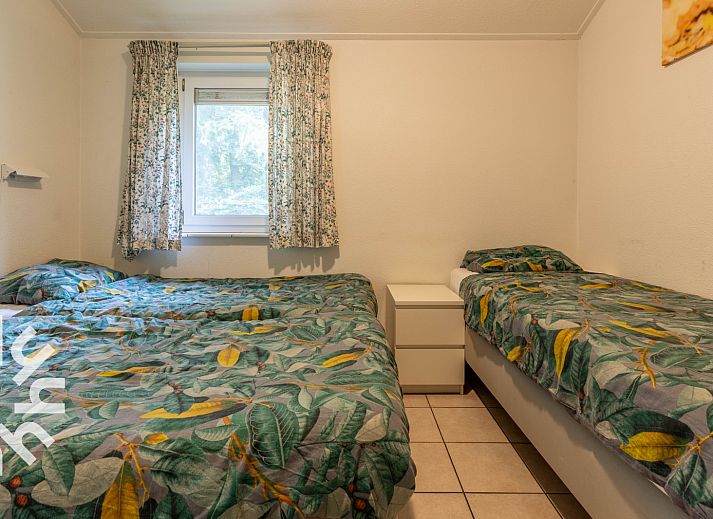 Bedroom in DG590 vacation home in Lochem, Achterhoek with comfortable bed and natural light.