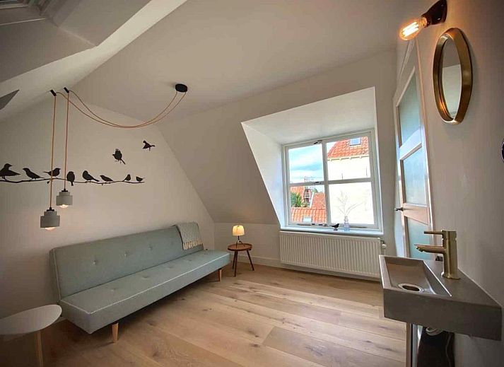 View from the window of vacation home DG1292 in Doesburg, Achterhoek, with historic roofs.