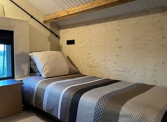 Cozy indoor area of Holiday Home in Zutphen, Achterhoek, Gelderland with fresh flowers and apples on the table.