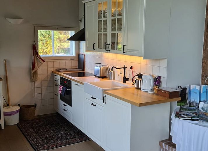Ruime eetkamer in Vakantiehuis in Vorden Achterhoek, Gelderland, met houten tafel en piano, ideaal voor een ontspannen verblijf.