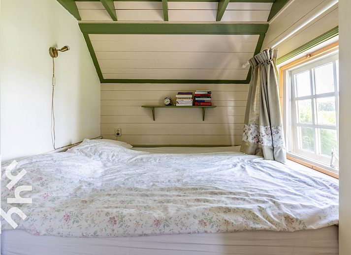 Terrace at vacation home DG496 in Vorden, Achterhoek, overlooking green fields.