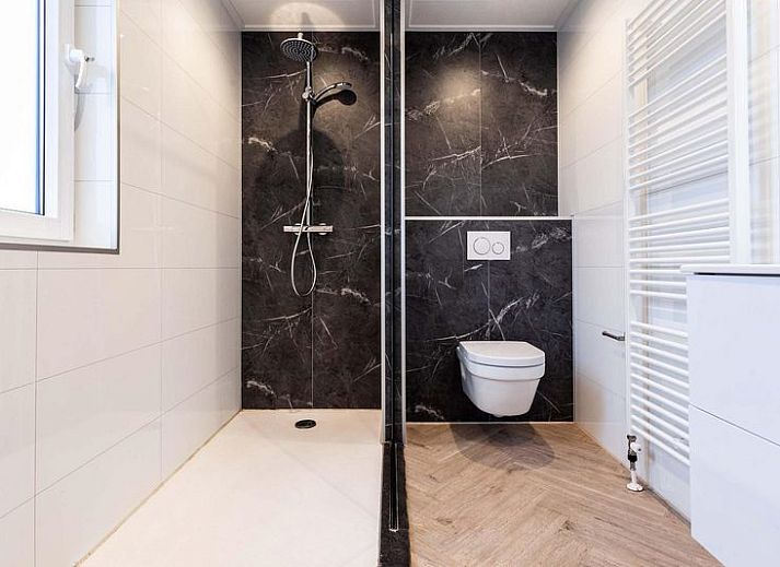 Comfortabele slaapkamer in Villa 12 personen Wellness, Lichtenvoorde met groot raam en kunstwerk.