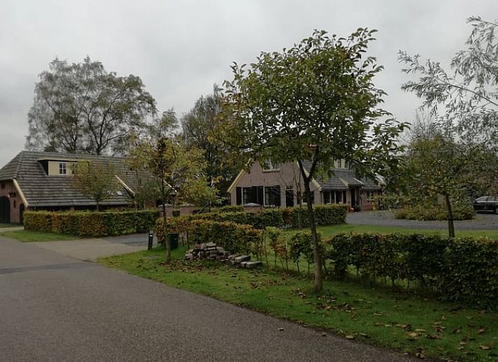 Eetgedeelte in Vakantiehuis in Gaanderen, Achterhoek, Gelderland, met grote houten tafel en uitzicht op de tuin.