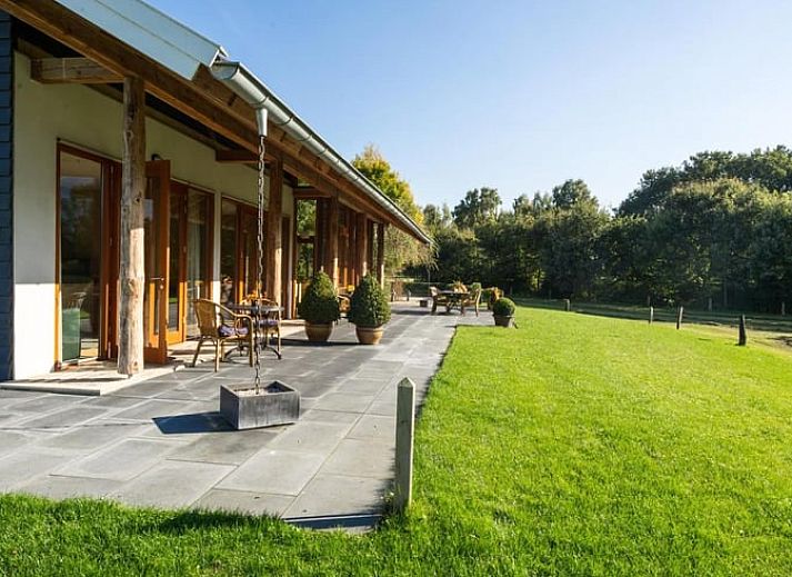 Atmospheric evening at Holiday home in Gaanderen, Achterhoek, Gelderland with illuminated porch.