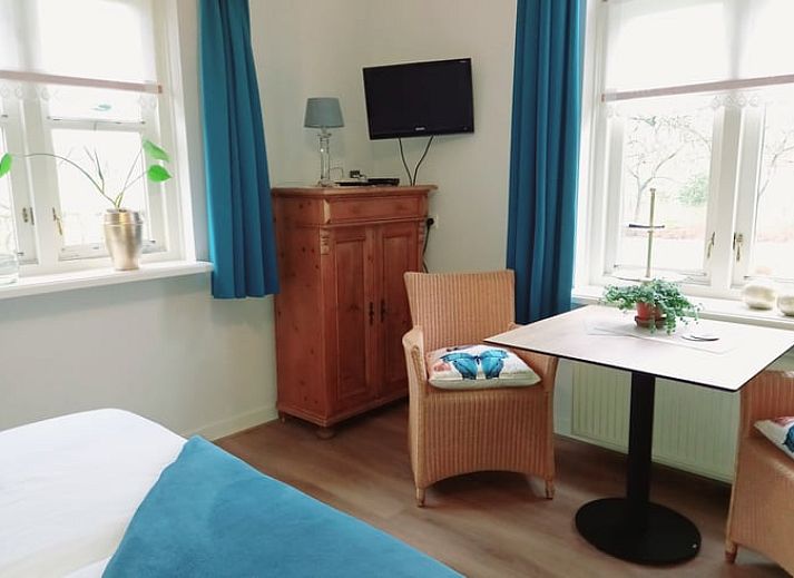 Cozy dining area in Holiday home in Gaanderen, Achterhoek, Gelderland with wood stove.
