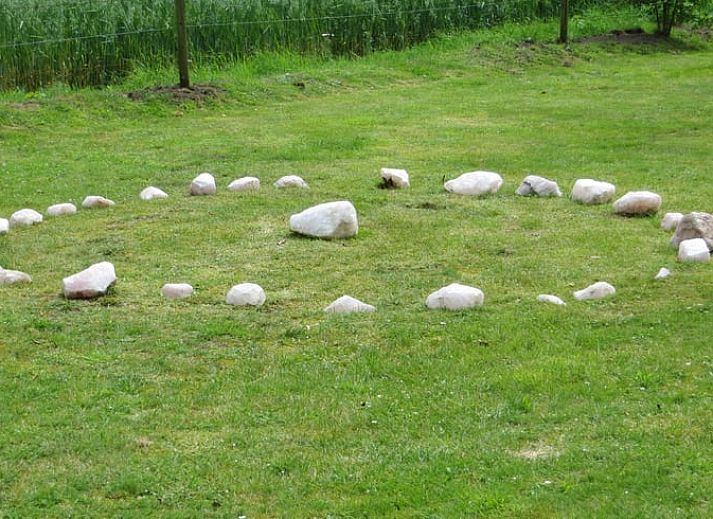 Cozy bedroom in Cottage in Warnsveld, Achterhoek, with colorful blankets and bedside tables.