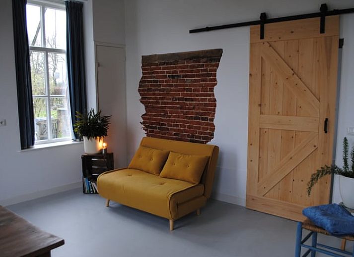 Ferienhaus in Winterswijk Woold mit traditioneller Backsteinfassade und gruenen Fensterlaeden, gelegen in Achterhoek, Gelderland.