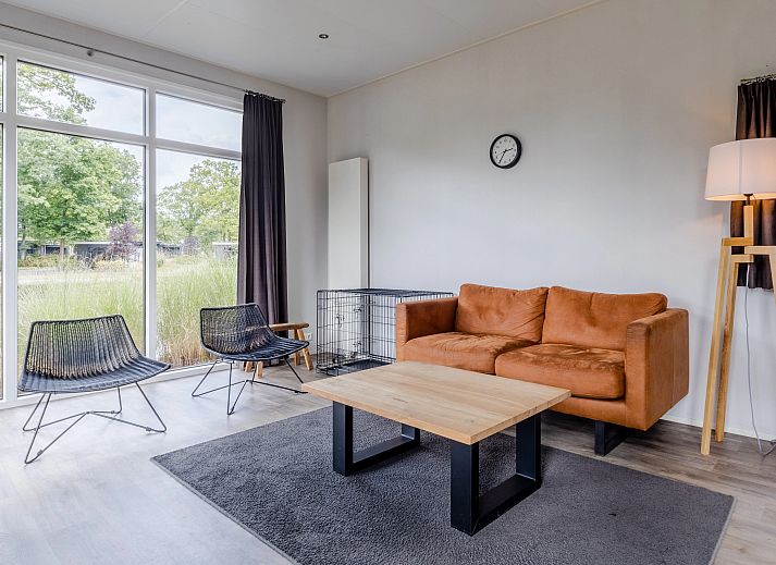 Cozy living room in De Vlinderhoeve, 4-bed bungalow in Kring van Dorth, Achterhoek, with comfortable sofa and modern furnishings.