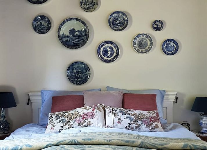 Cozy bedroom in Cottage in Voorst, Oude IJsselstreek, with decorative signs on the wall, located in Achterhoek, Gelderland.