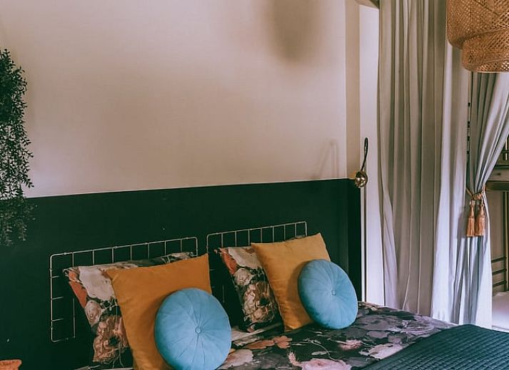 Cozy bedroom in Cottage in Voorst, Oude IJsselstreek, with decorative signs on the wall, located in Achterhoek, Gelderland.