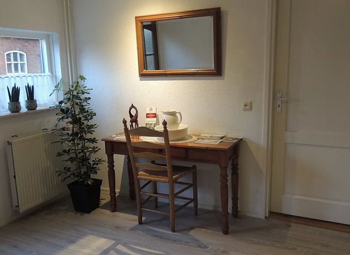 Cozy living room of Holiday Home in Winterswijk Corle, Achterhoek, with comfortable sitting area and dining area for a relaxing stay.