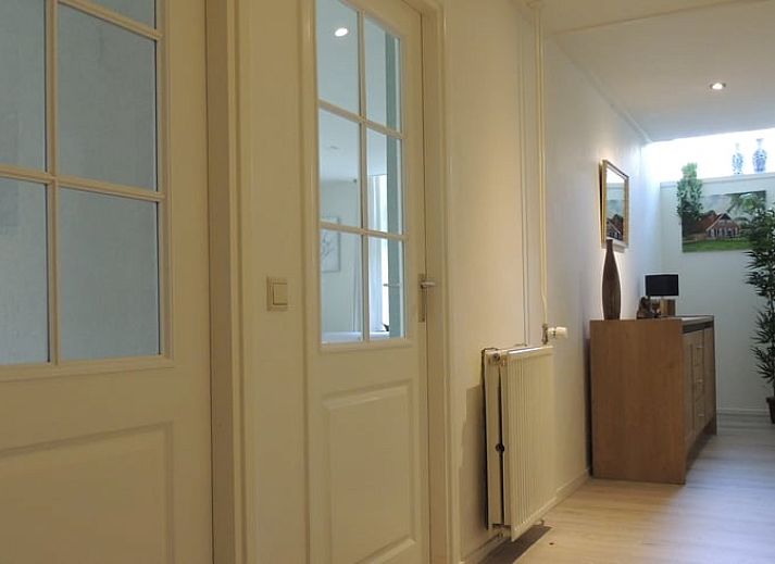 Cozy living room of Holiday Home in Winterswijk Corle, Achterhoek, with comfortable sitting area and dining area for a relaxing stay.