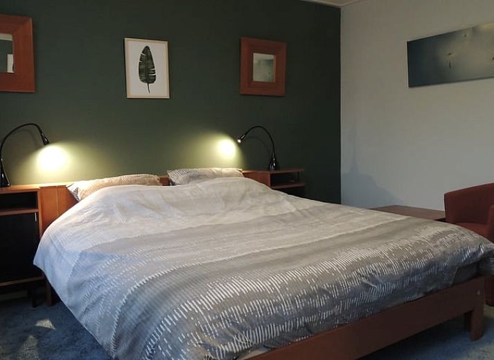 Cozy living room of Holiday Home in Winterswijk Corle, Achterhoek, with comfortable sitting area and dining area for a relaxing stay.