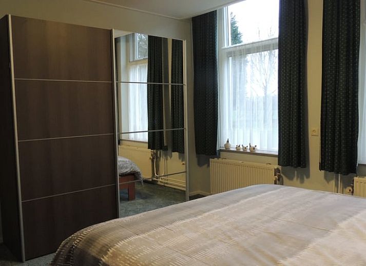 Cozy living room of Holiday Home in Winterswijk Corle, Achterhoek, with comfortable sitting area and dining area for a relaxing stay.