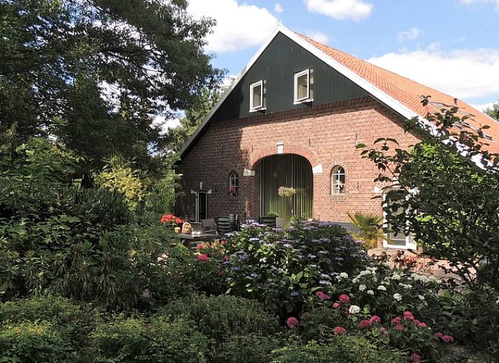 Cozy living room in Holiday Home in Winterswijk Corle, Achterhoek, Gelderland, with comfortable seating area and modern furnishings.