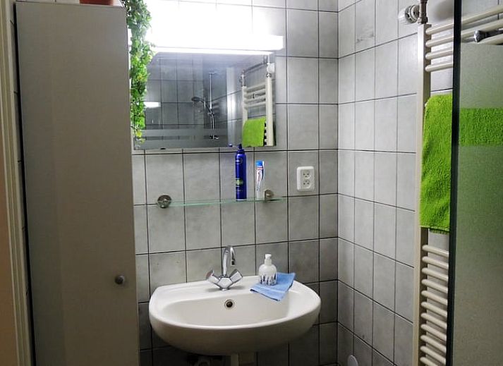 Modern living room with TV in Holiday home in Winterswijk Corle, perfect for relaxation in Achterhoek, Gelderland.