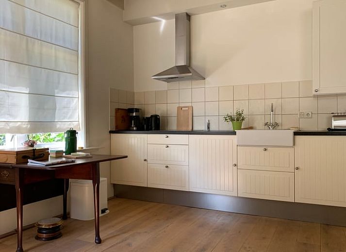 Vacation home in Corle, Winterswijk Corle, surrounded by green garden and blue sky in Achterhoek, Gelderland.