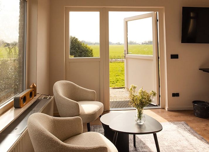 Cozy sitting area in cottage in Wilp-Achterhoek overlooking the green fields of Gelderland.