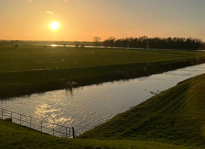 Cottage in Bronkhorst cottage in the valley of Gelderland, surrounded by green fields and blue skies in Gelderland.