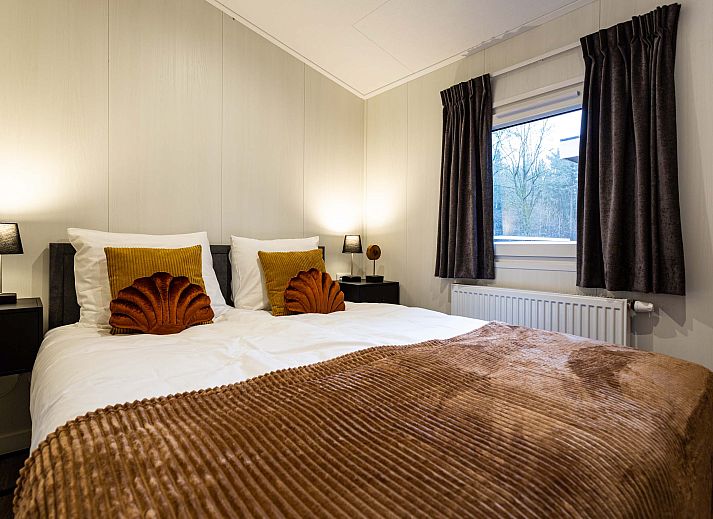 Stylish kitchen in Luna vacation home, Ede, Veluwe, with wooden cabinets and appliances.