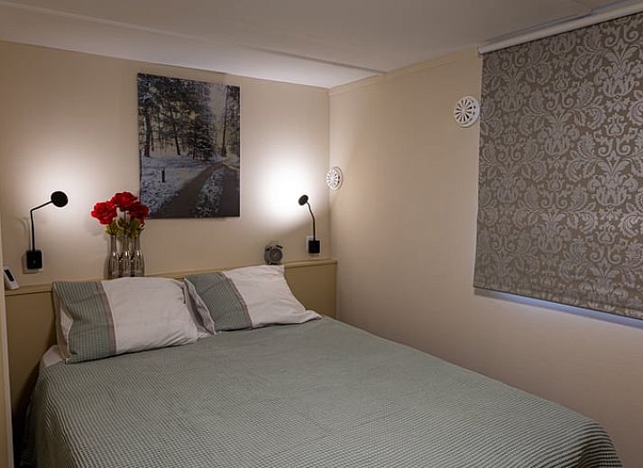 Dining area in Holiday home in Emst, Gelderland, with modern chairs and table.