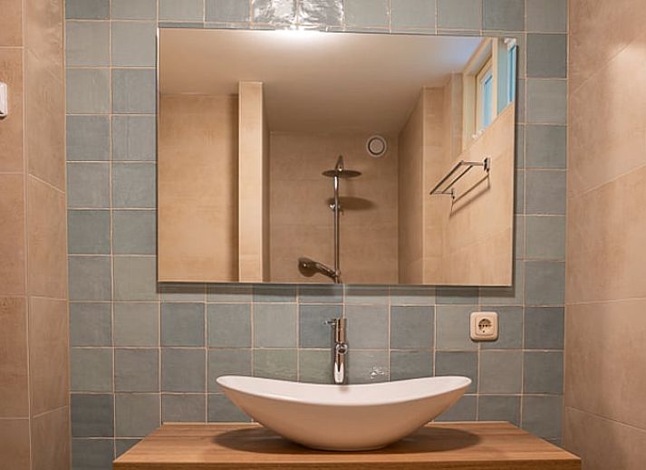 Attractive bedroom in Holiday Home in Emst, located in the Veluwe in Gelderland, with views of green nature through a large window.