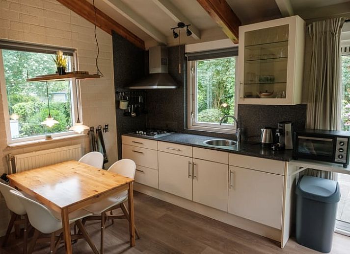 Enjoy a relaxed breakfast on the terrace of Huisje in Ermelo, a cozy vacation home in the Veluwe, Gelderland.