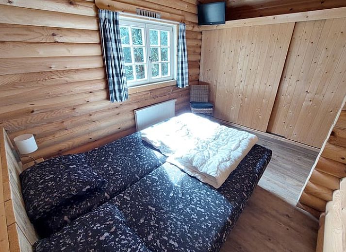 Geniessen Sie die waldige Aussicht von der Veranda des Huisje in Ermelo, einem gemuetlichen Ferienhaus an der Veluwe in Gelderland.