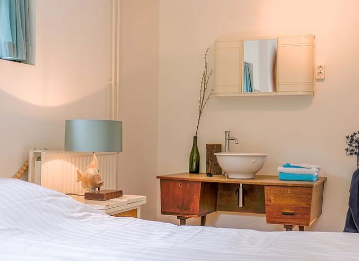 Gezellige woonkamer in Huisje in Ermelo, Veluwe, met kleurrijke stoelen en uitzicht op de natuur in Gelderland.