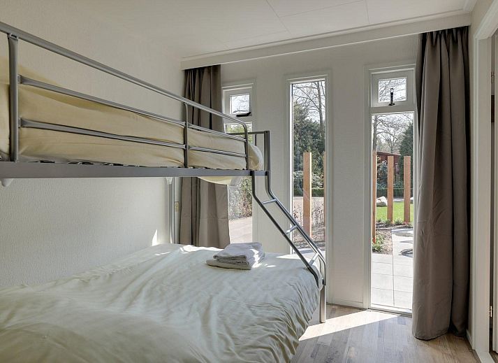 Flowers and wooden poles in the garden of Cozy Lodge in Harderwijk, Veluwe, Gelderland.